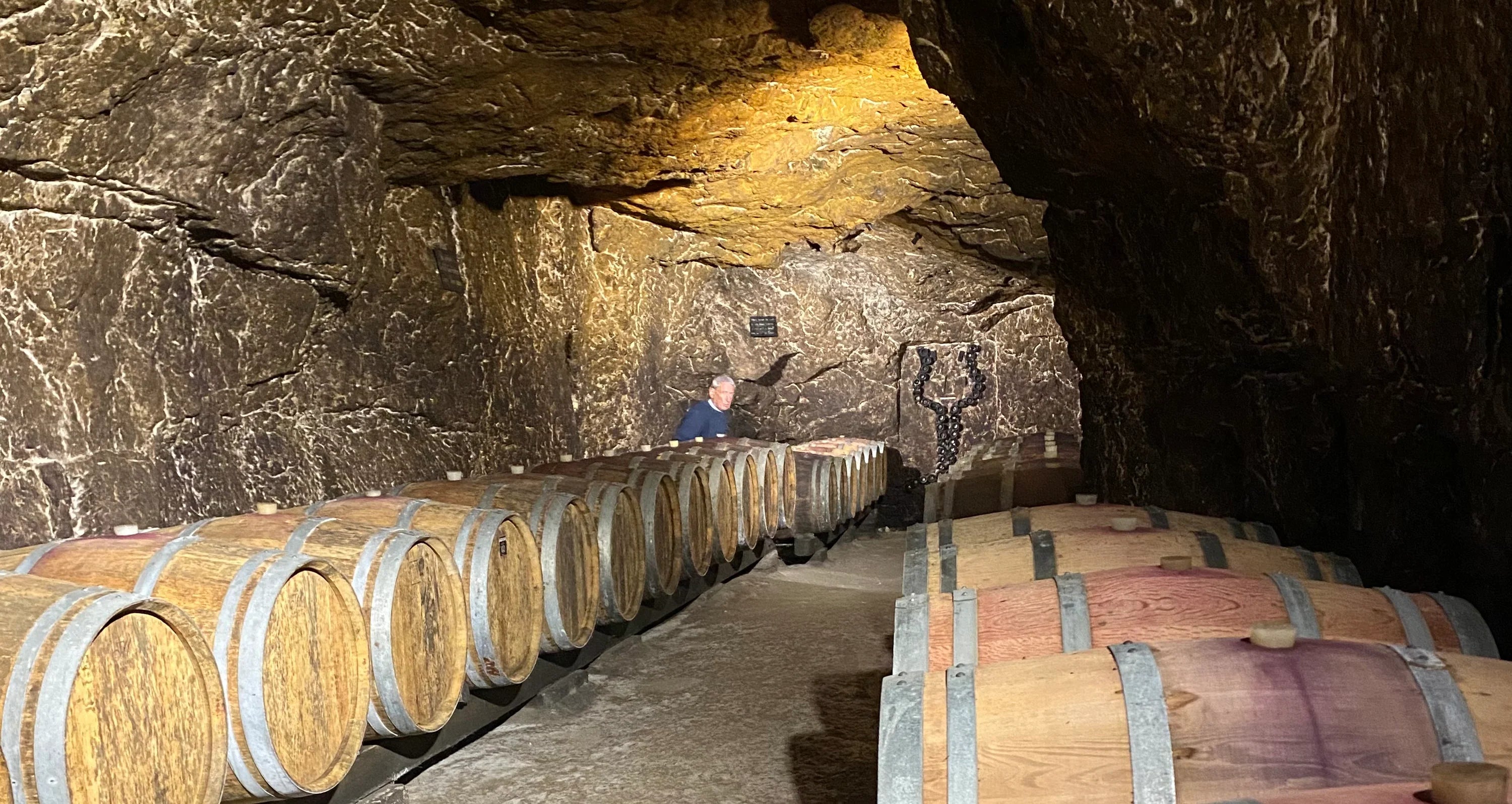 A winemaker working among barrels